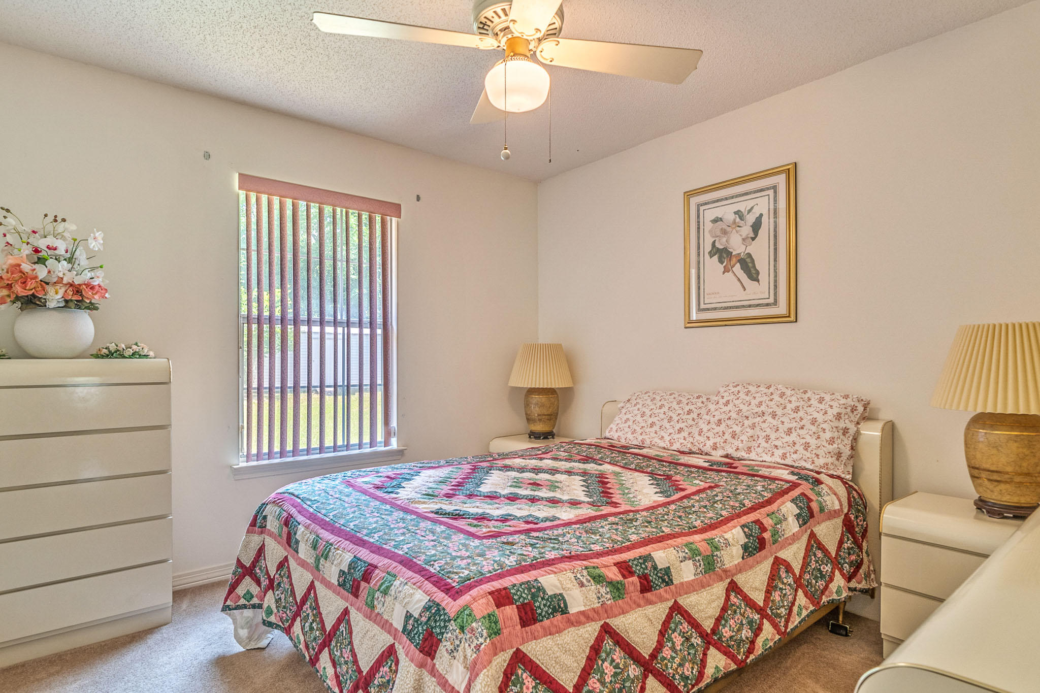 6087 Bud Moulton Road Crestview, FL 32536 - Photo 18 of 30 a bedroom with a bed and a chandelier
