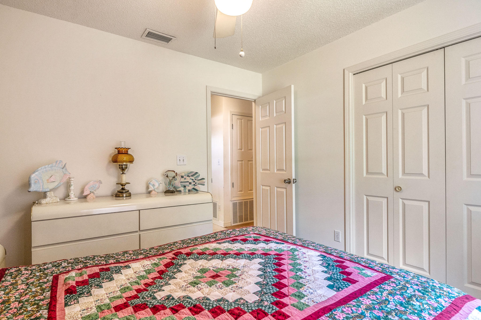 6087 Bud Moulton Road Crestview, FL 32536 - Photo 19 of 30 a room with a bed and a dresser