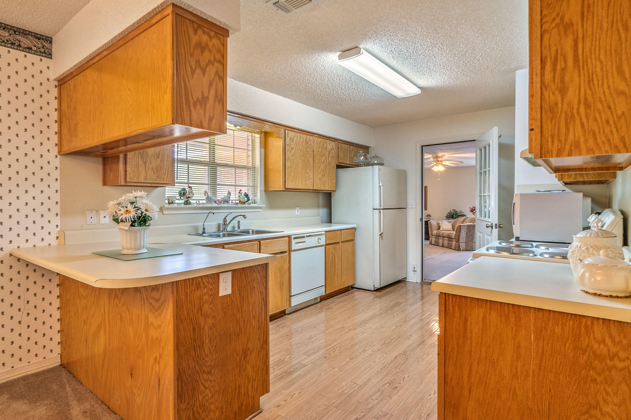 6087 Bud Moulton Road Crestview, FL 32536 - Photo 5 of 30 a kitchen with stainless steel appliances granite countertop a sink and a granite counter tops with wooden floors