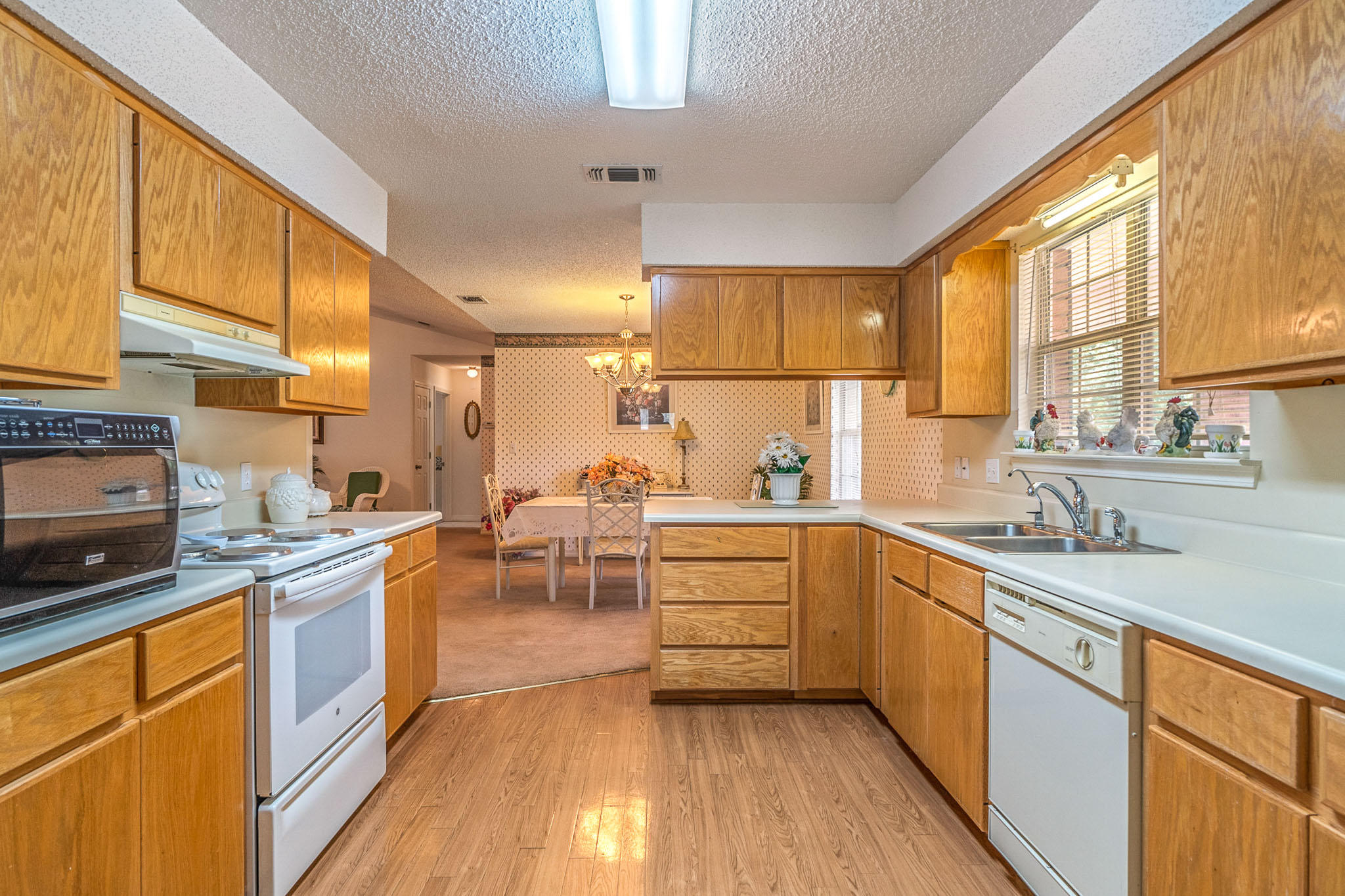 6087 Bud Moulton Road Crestview, FL 32536 - Photo 6 of 30 a kitchen with stainless steel appliances a sink cabinets and wooden floor