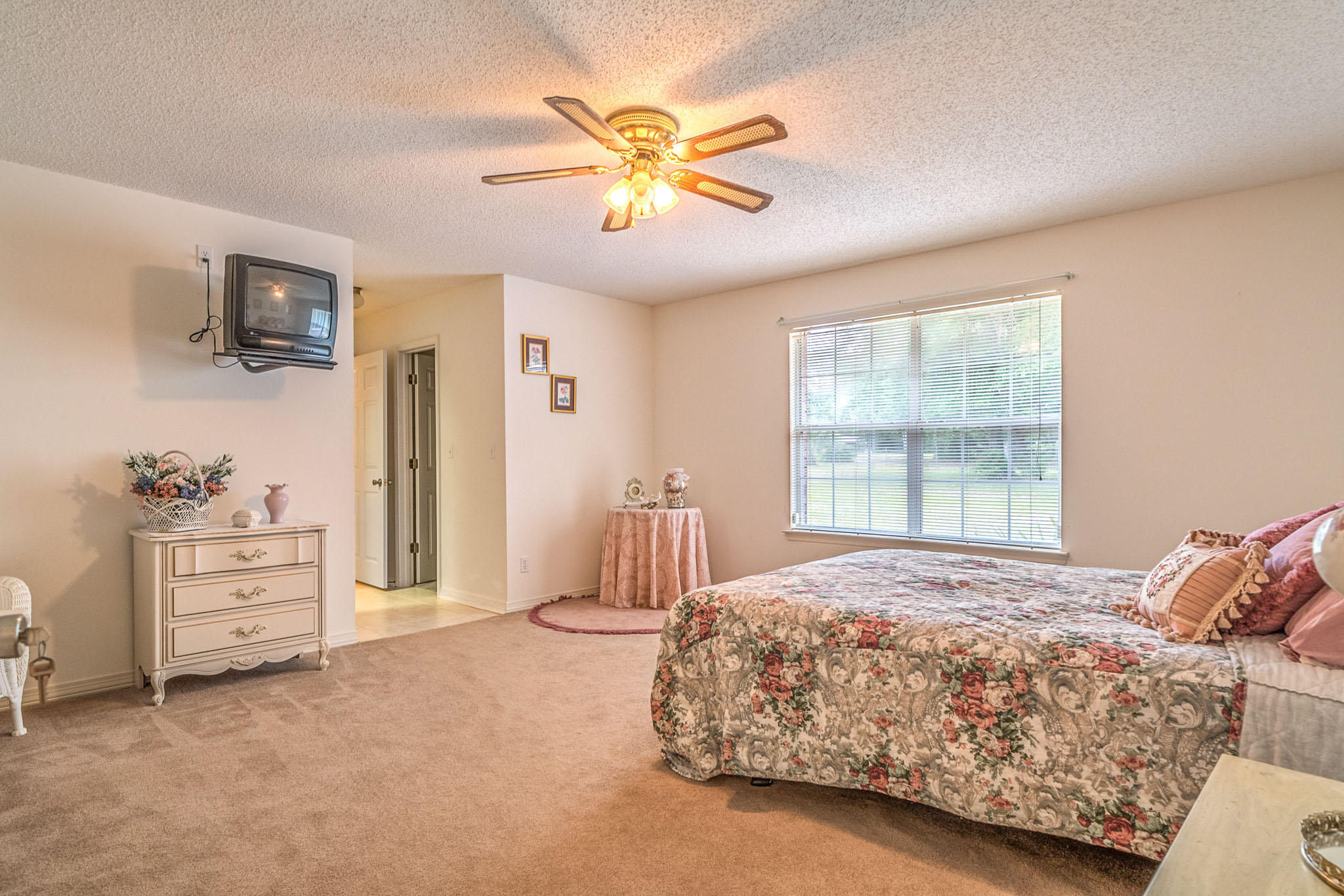 6087 Bud Moulton Road Crestview, FL 32536 - Photo 7 of 30 a bedroom with a bed and a chandelier