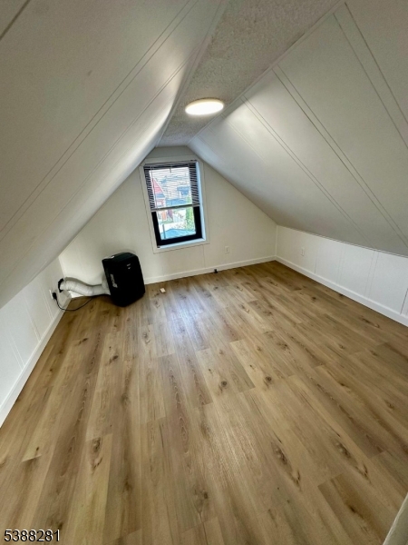 9 Fraser Street, Unit 2 Woodbridge, NJ 08863 - Photo 12 of 16 an empty room with wooden floor and windows