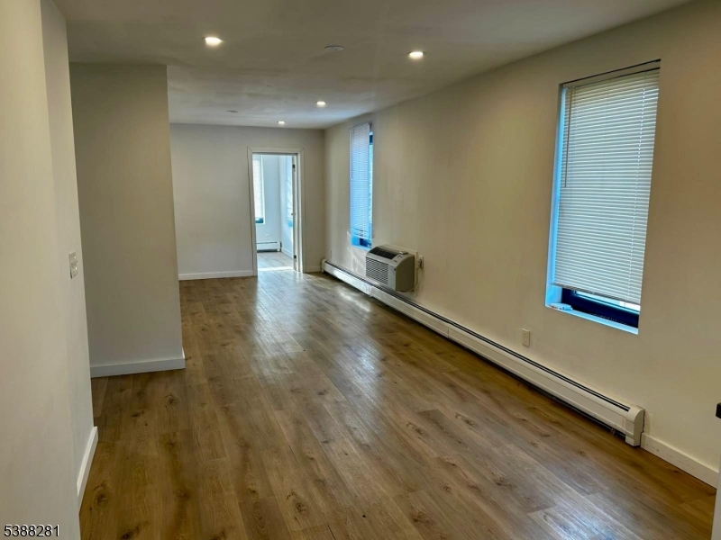 9 Fraser Street, Unit 2 Woodbridge, NJ 08863 - Photo 3 of 16 an empty room with wooden floor and windows