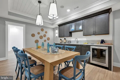 a kitchen with stainless steel appliances granite countertop a sink a stove and chairs