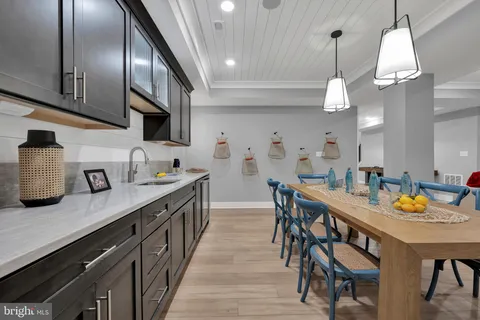 a view of a dining room with furniture and a chandelier fan