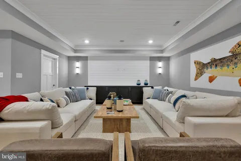 a living room with furniture and a view of kitchen
