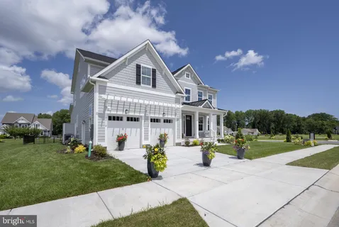 a front view of a house with a porch and a yard