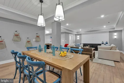 a living room with furniture a lamp and a view of kitchen