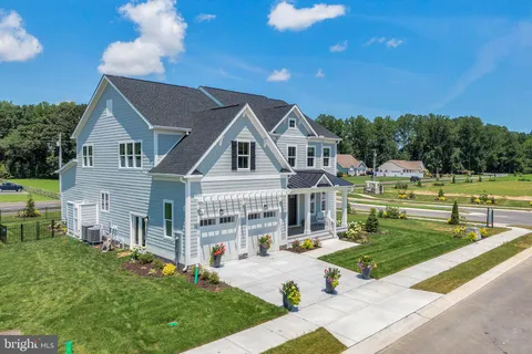 a view of a house with backyard porch and sitting area