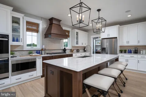 a kitchen with stainless steel appliances granite countertop a sink and cabinets