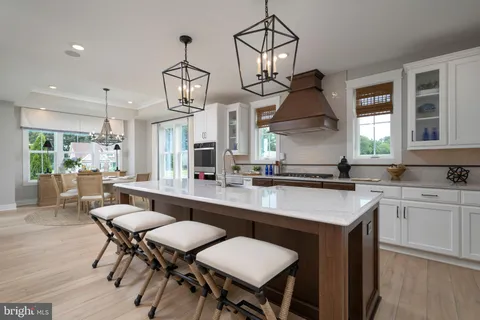 a bathroom with a granite countertop toilet sink and mirror
