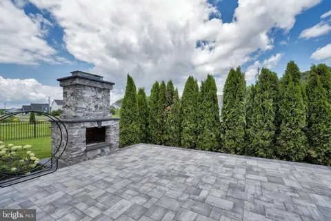 a front view of a house with garden and seating area