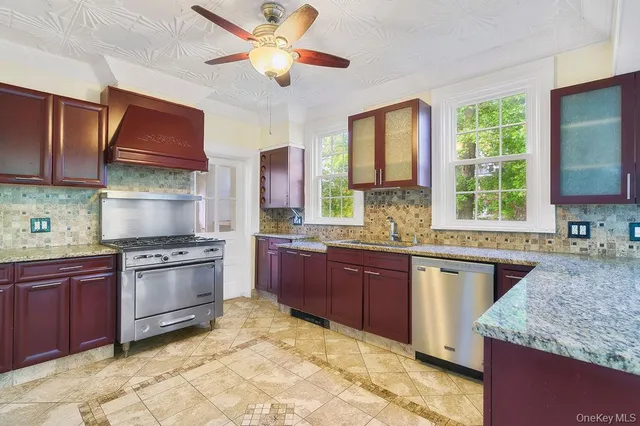 a kitchen with stainless steel appliances granite countertop a stove sink and microwave