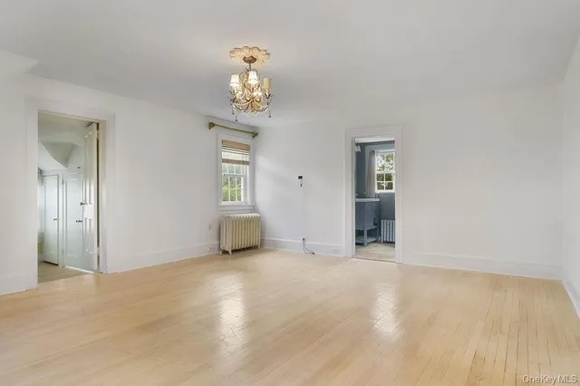 an empty room with windows and entrance