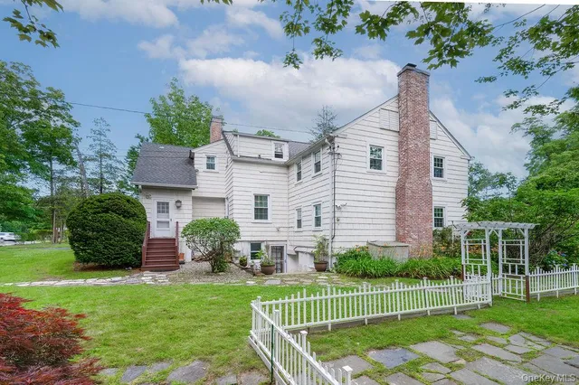 a view of a house with a yard and a garden