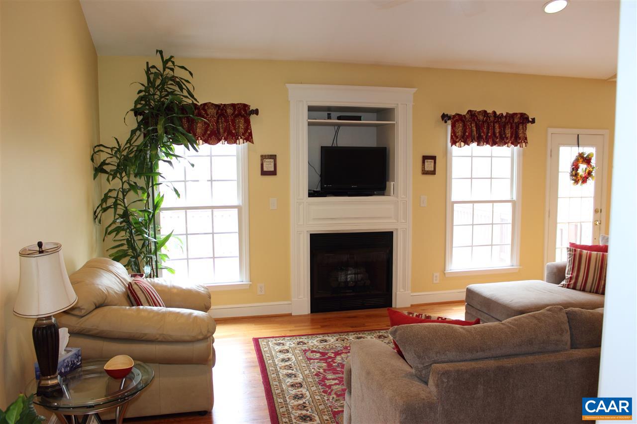 79 Riverside Drive Palmyra, VA 22963 - Photo 5 of 17 a living room with furniture a flat screen tv and a fireplace