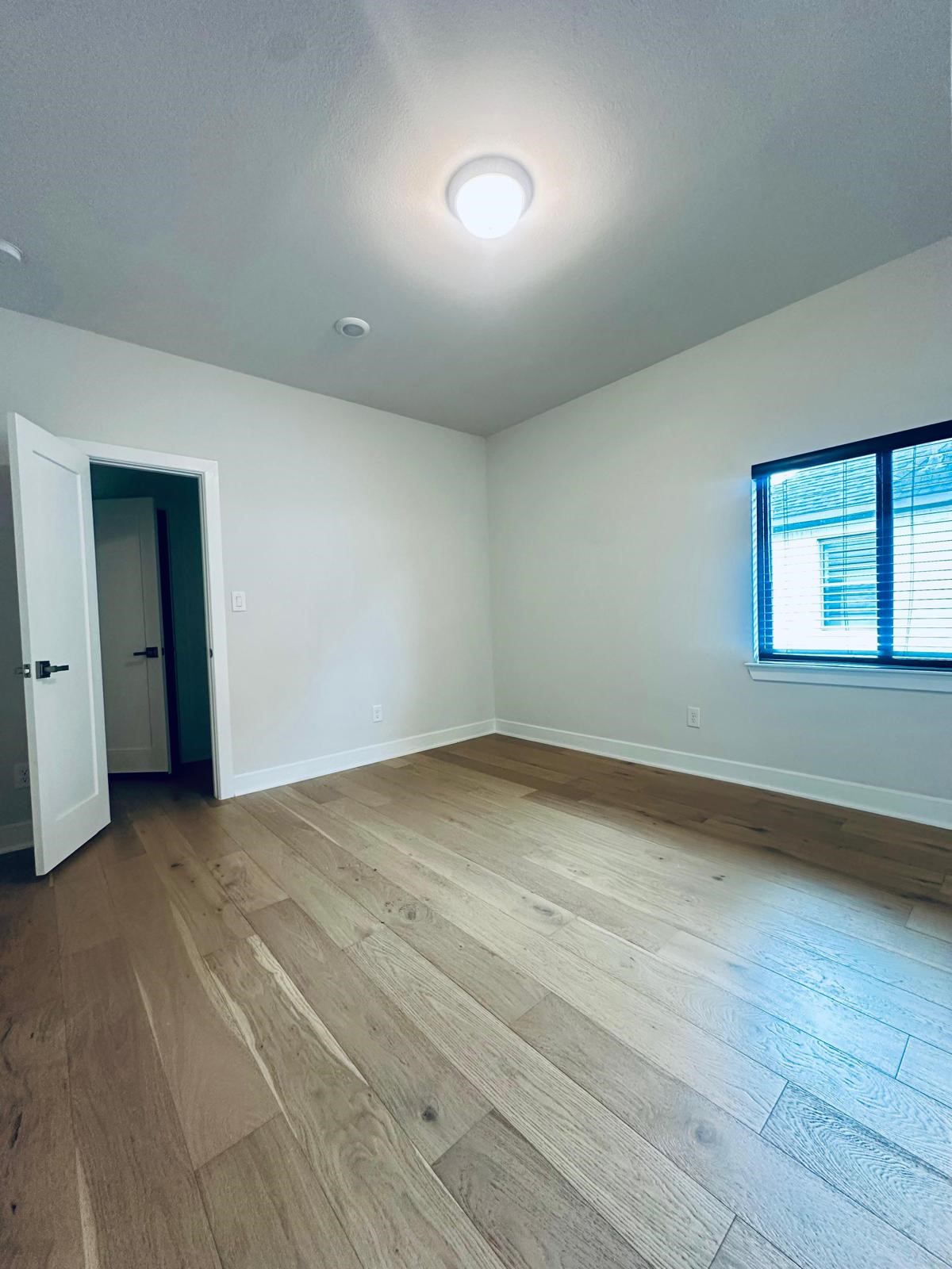 6 Gentle Branch Place Tomball, TX 77375 - Photo 11 of 46 an empty room with a empty space and windows
