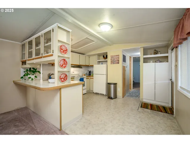 a kitchen with stainless steel appliances a refrigerator sink and microwave