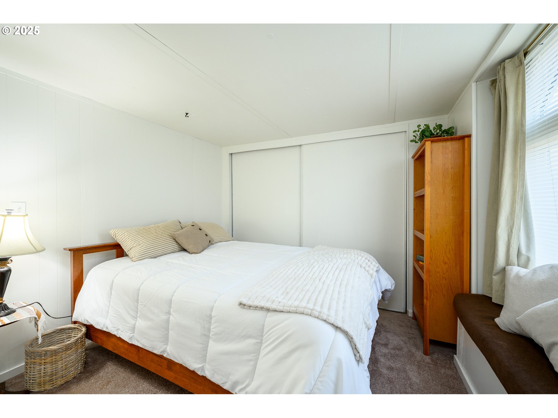 2902 East 2nd Street, Unit 108 Newberg, OR 97132 - Photo 26 of 38 a bedroom with a bed and a large window