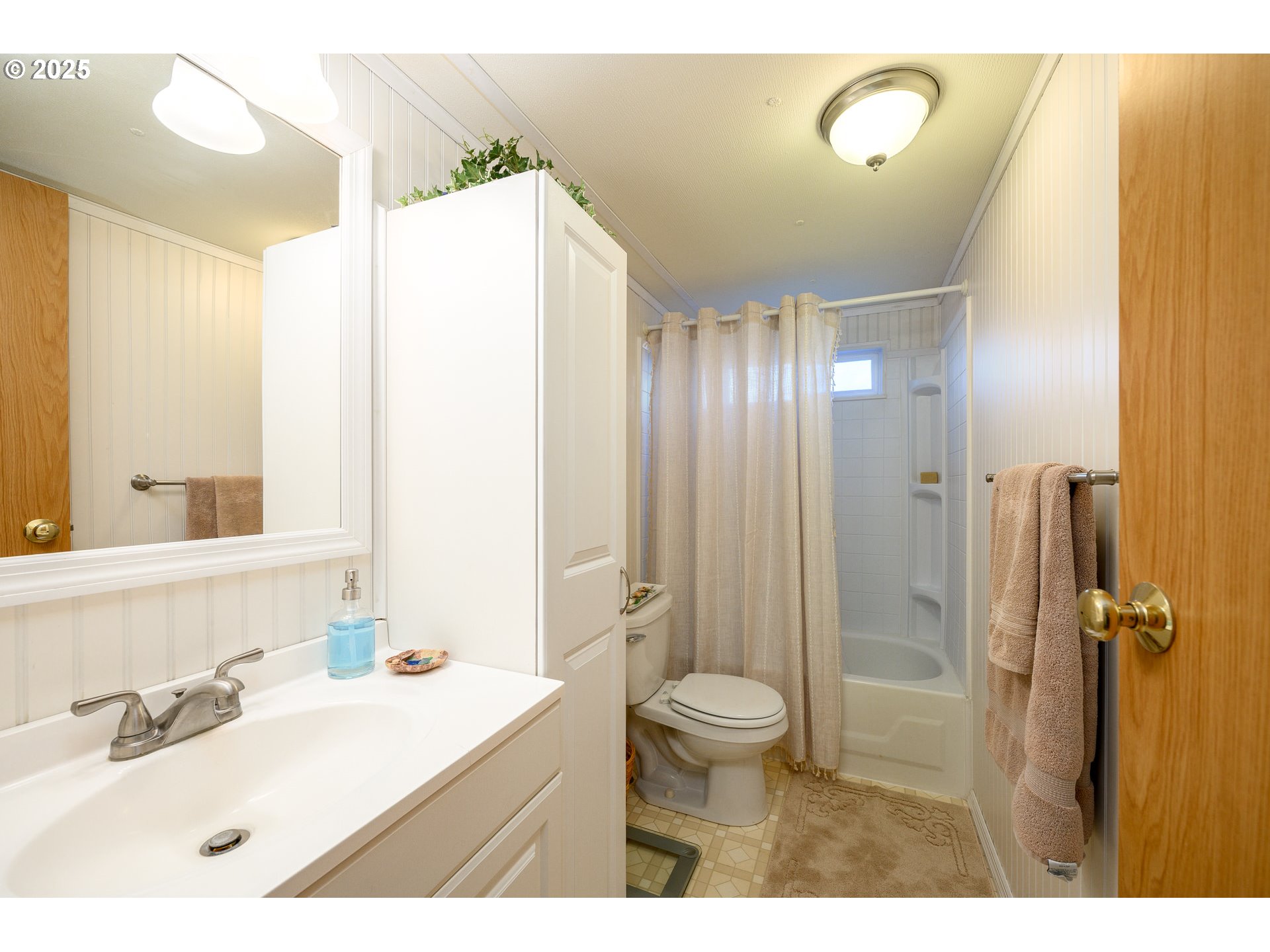 2902 East 2nd Street, Unit 108 Newberg, OR 97132 - Photo 27 of 38 a bathroom with a sink a toilet a mirror and shower