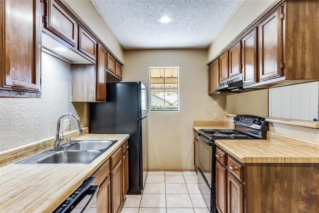 825 Blue Ridge Drive Burleson, TX 76028 - Photo 12 of 25 Kitchen featuring recently updated appliances Refrigerator is negotiable.