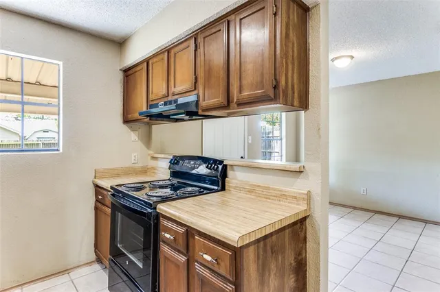 a kitchen with stainless steel appliances granite countertop a sink and a stove