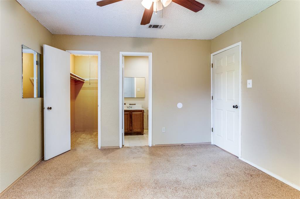 825 Blue Ridge Drive Burleson, TX 76028 - Photo 17 of 25 Another view of the primary bedroom with a spacious walk-in closet, carpet and half bath