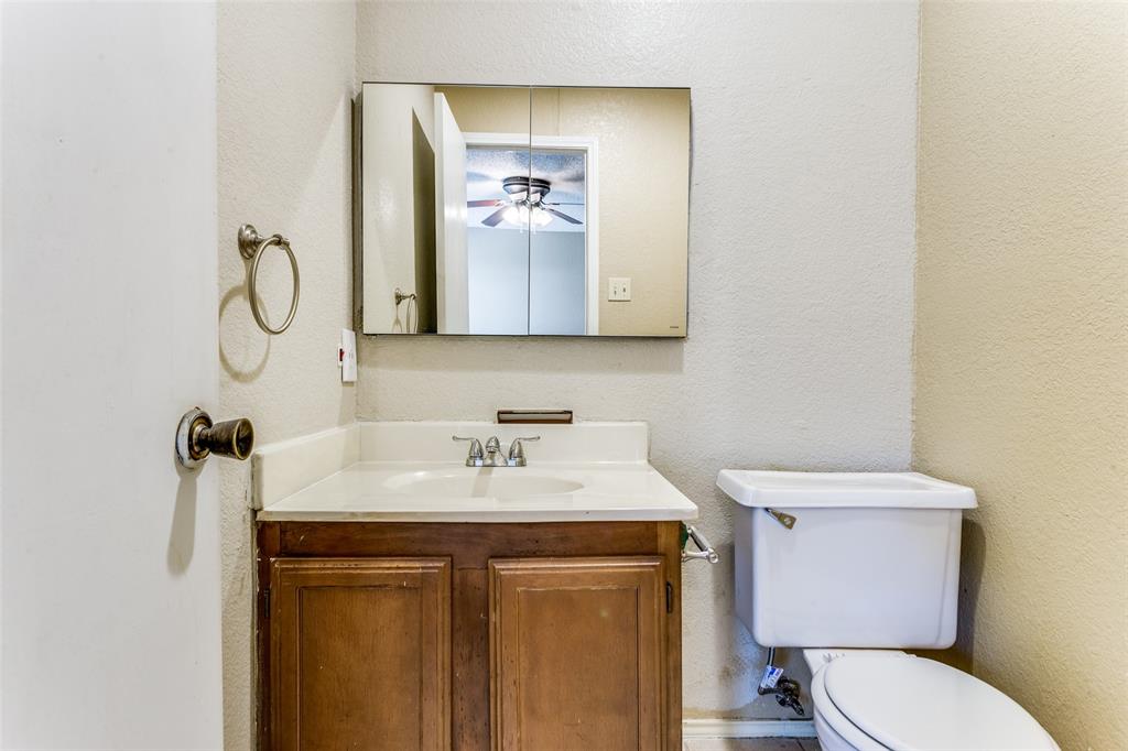 825 Blue Ridge Drive Burleson, TX 76028 - Photo 18 of 25 Half bath located inside the primary bedroom.