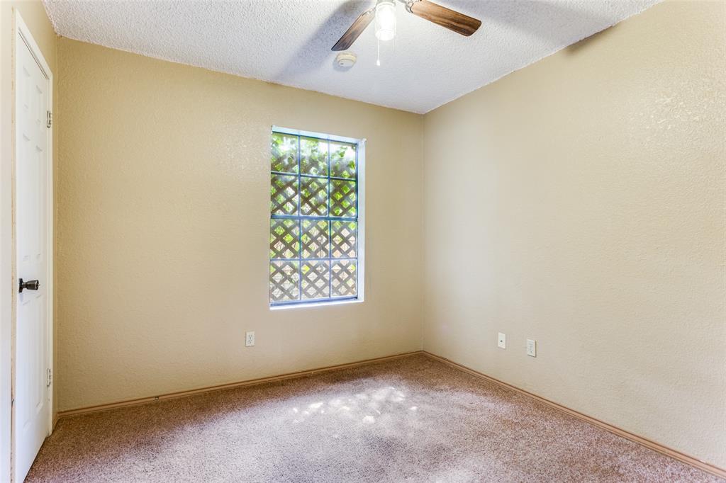 825 Blue Ridge Drive Burleson, TX 76028 - Photo 19 of 25 Secondary bedroom featuring carpet, spacious closet and ceiling fan.