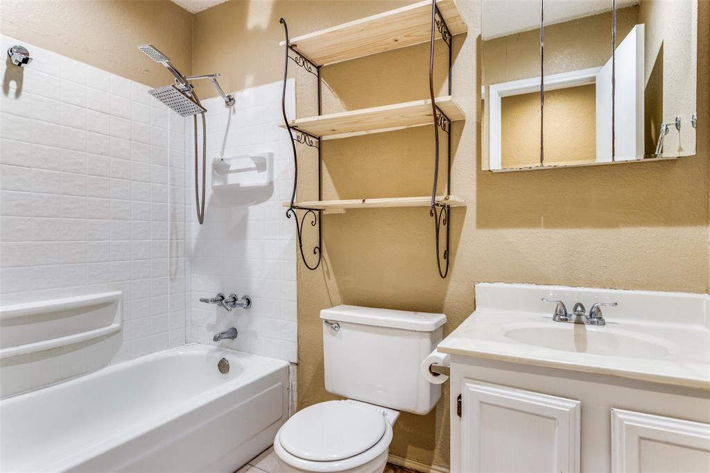 825 Blue Ridge Drive Burleson, TX 76028 - Photo 20 of 25 Full bath located in the hallway between the secondary and primary bedrooms. Bathroom features tub-shower combo and ceramic tile flooring.