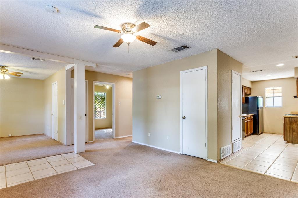 825 Blue Ridge Drive Burleson, TX 76028 - Photo 7 of 25 Another view from the main living area exposing second living area and one of the secondary bedrooms and kitchen.