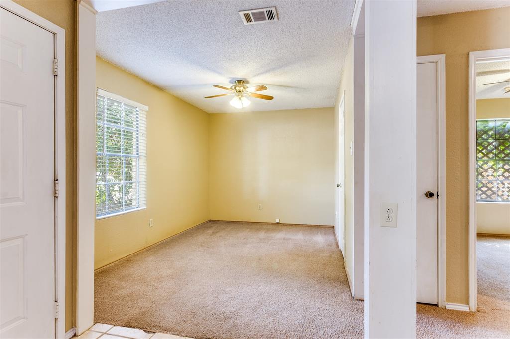 825 Blue Ridge Drive Burleson, TX 76028 - Photo 8 of 25 Second living area with light carpet, a textured ceiling, and ceiling fan. Room also features a small closet and a window overlooking the front yard. Would make a perfect home office or with a little work, a 3rd bedroom if needed.