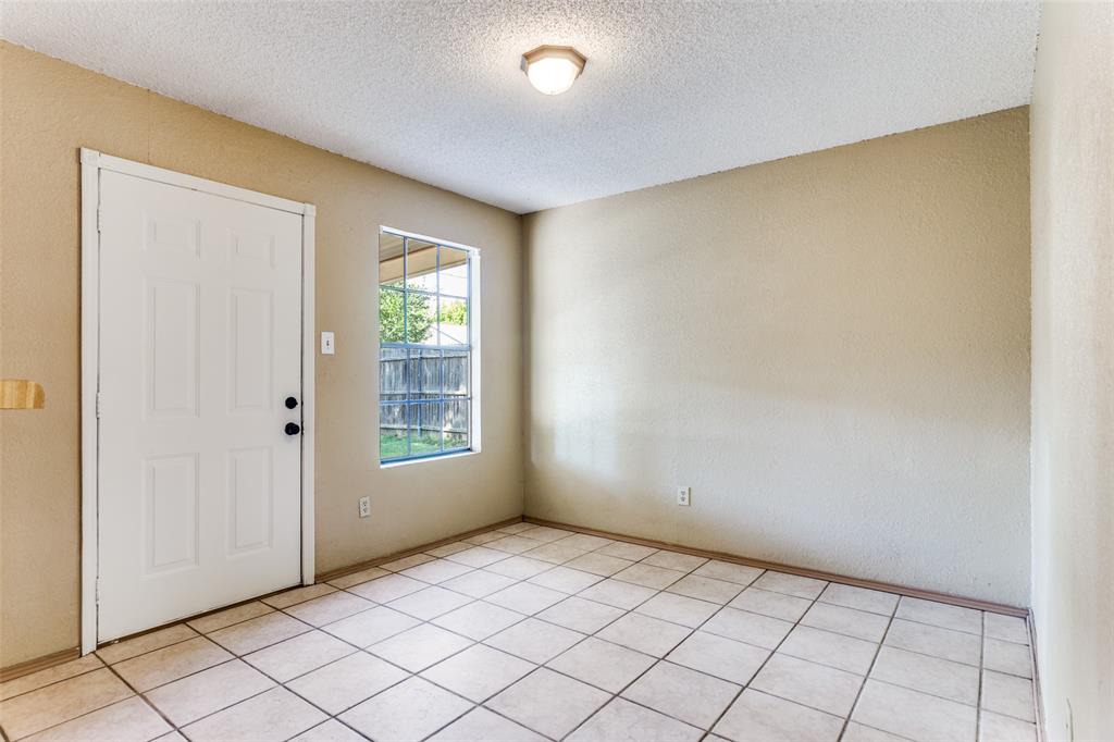 825 Blue Ridge Drive Burleson, TX 76028 - Photo 9 of 25 Breakfast area with ceramic tile. Door accesses back yard, window with back yard view