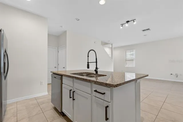 a kitchen with a sink and cabinets