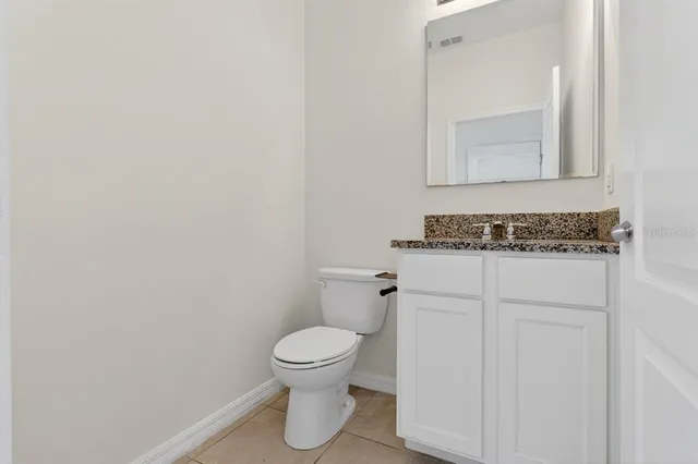 a white toilet sitting next to a bathroom sink