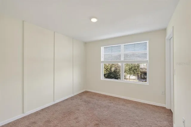 an empty room with windows and closet
