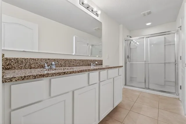 a bathroom with a glass shower door