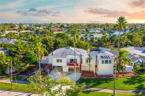 an aerial view of a house with swimming pool garden and lake view