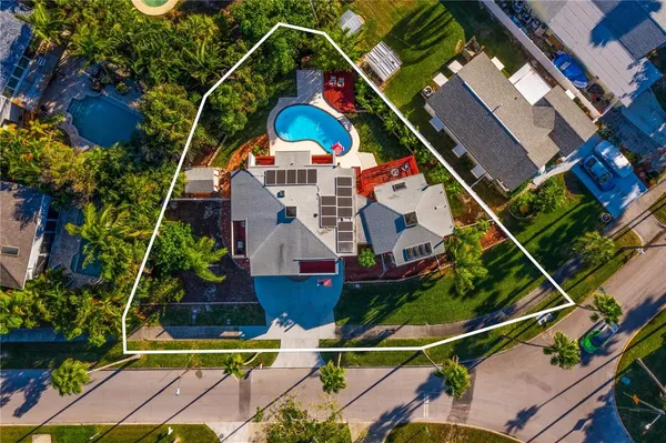 an aerial view of house with yard swimming pool and outdoor seating