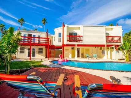 an aerial view of house with yard swimming pool and outdoor seating