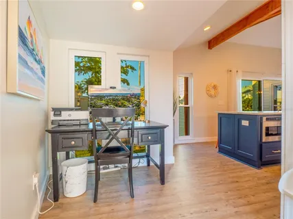 a kitchen with counter top space and wooden floor