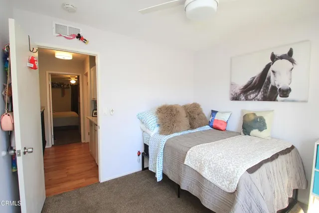 a bedroom with a bed and the view of bathroom