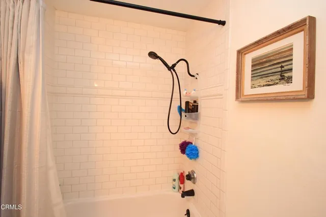 a bathroom with a shower and a shower