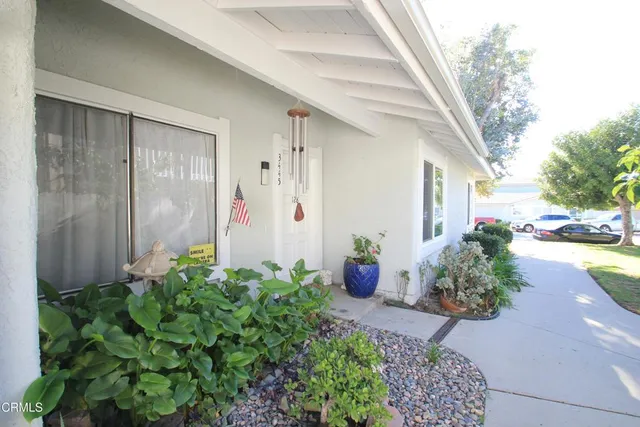 a front view of a house with potted plants