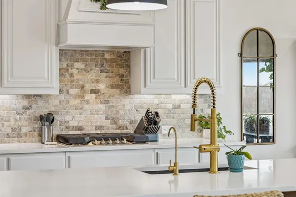 a kitchen with a faucet a sink and cabinets