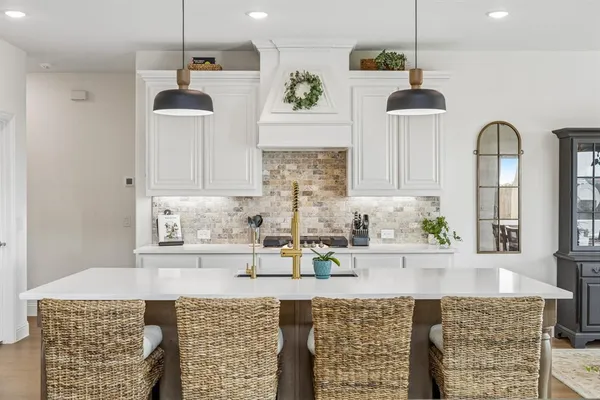 a kitchen with stainless steel appliances granite countertop a sink a stove and a wooden floors