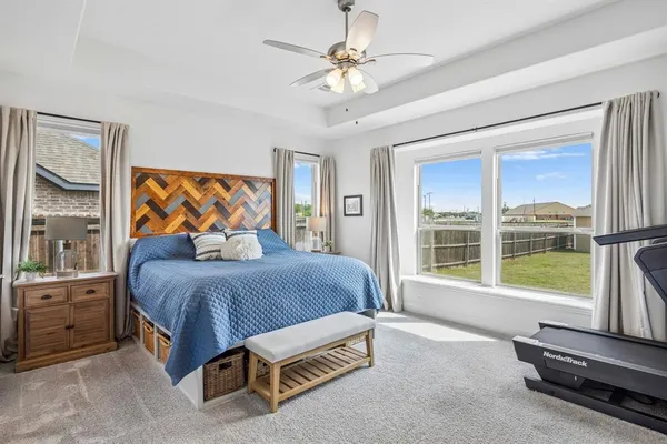 a bedroom with a bed and a large window