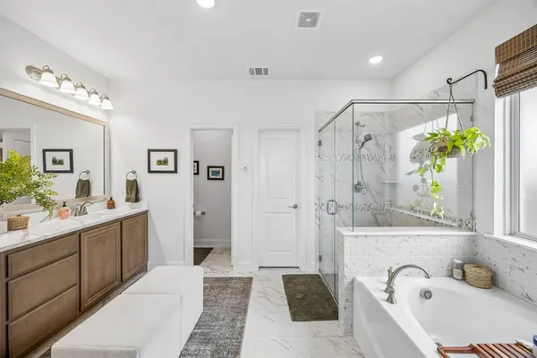a bathroom with a tub sink and mirror