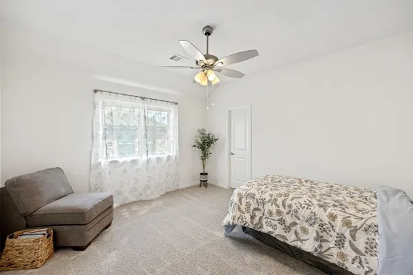 a bedroom with furniture and a window