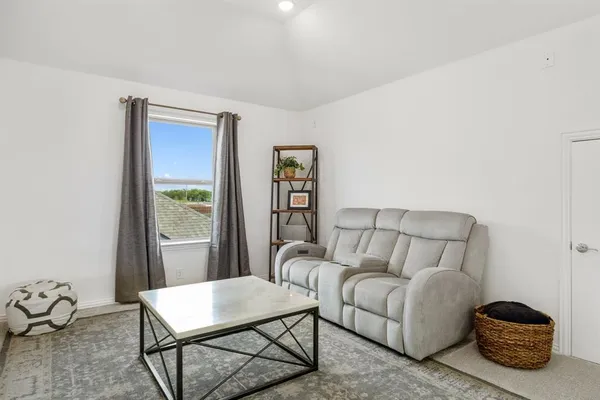 a living room with furniture a rug and a window
